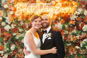 The bride and groom hold each other close underneath their neon sign, "Best day Ever"!