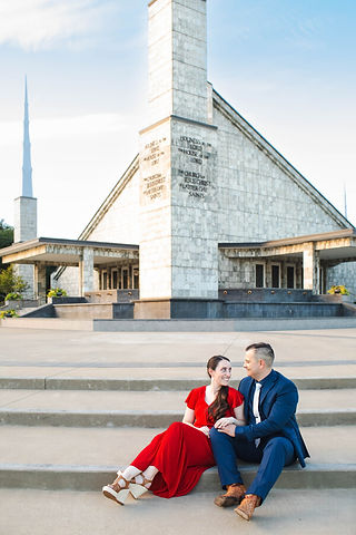 A man and woman sit on the steps in front of the Dallas TX LDS temple on their 1 year anniversary.