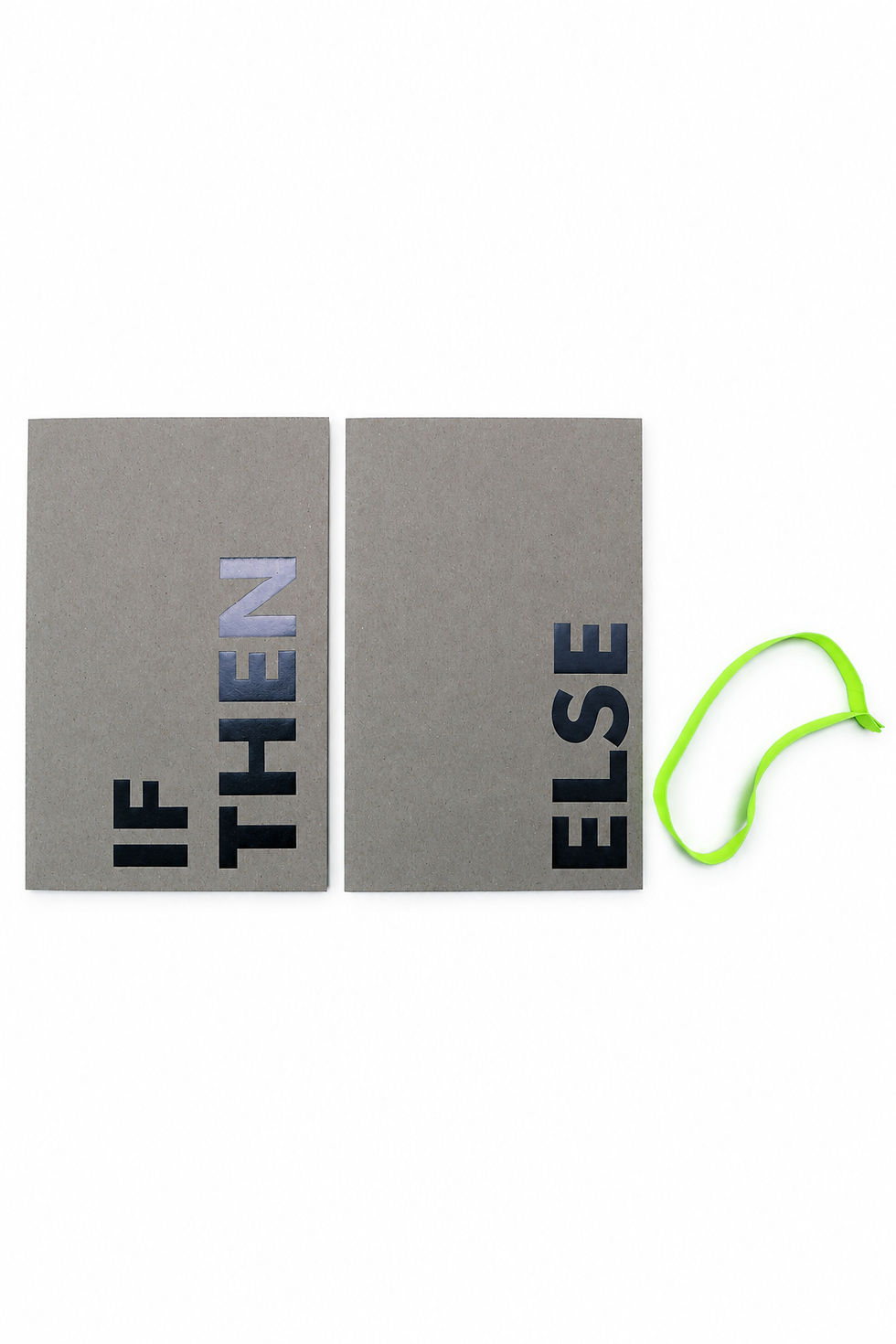 The two grey IF THEN and ELSE catalogue volumes laid side by side, with the green elastic band beside them.