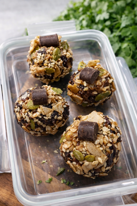 Four healthy energy bites with chocolate and seeds