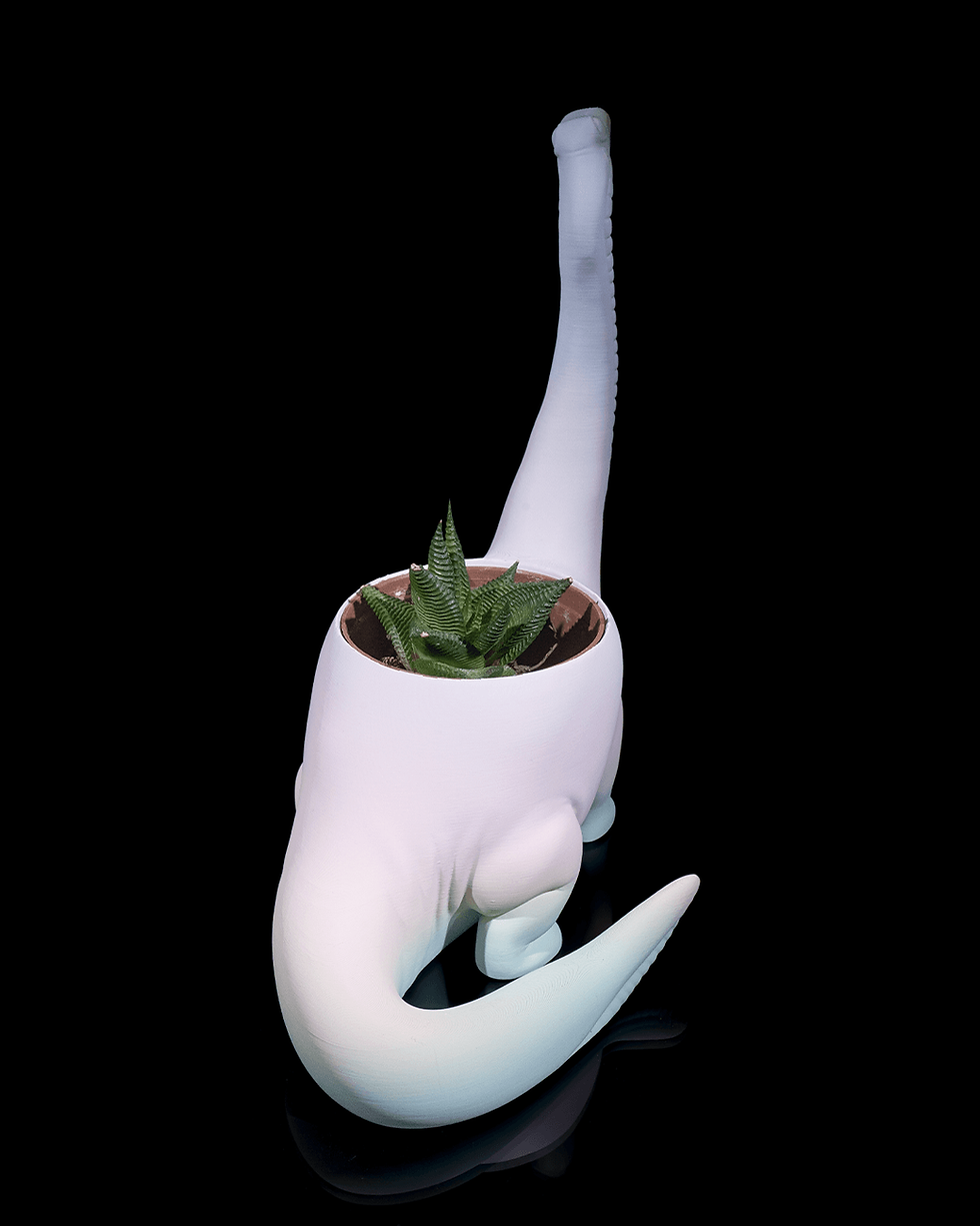 थंबनेल: Pastel dinosaur planter with succulent