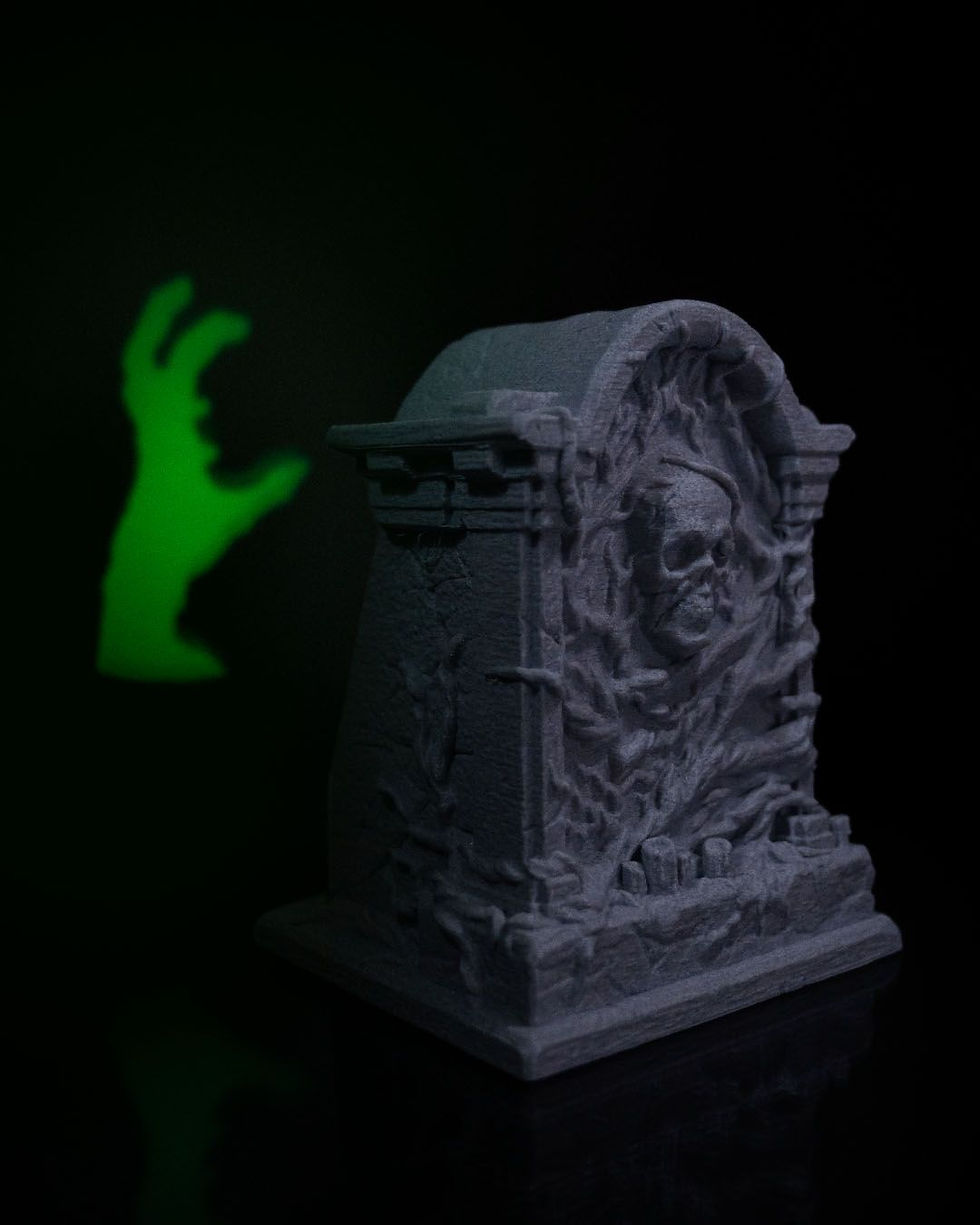 Thumbnail: Glowing hand near skull-carved grave