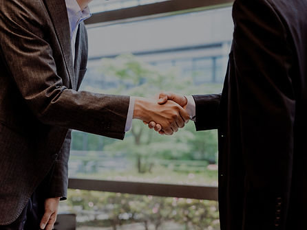 Bookkeeper providing one-on-one bookkeeping consultation on a phone call with financial documents on a desk.