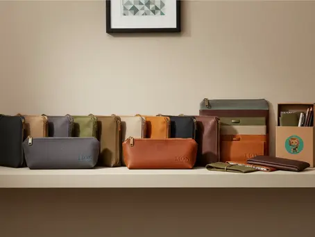 An array of custom-branded canvas and leather pencil pouches showcased on a retail display shelf.