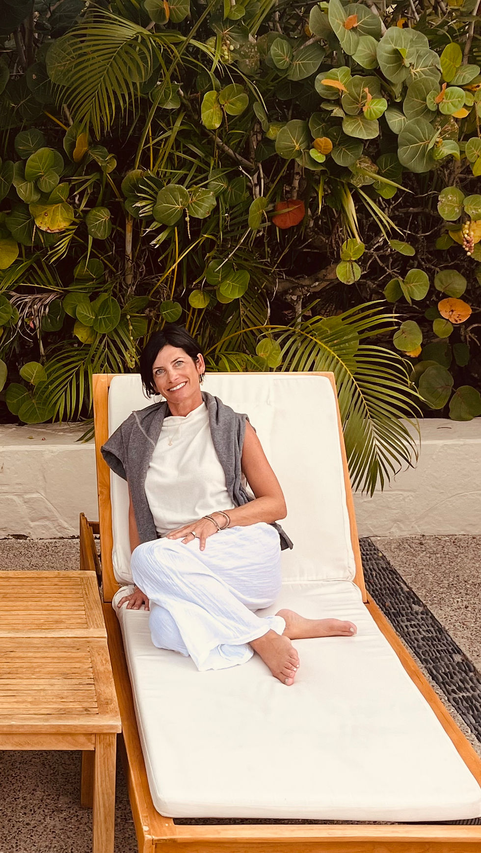 Founder of Kimberly Vision Bar relaxing on a lounge chair.