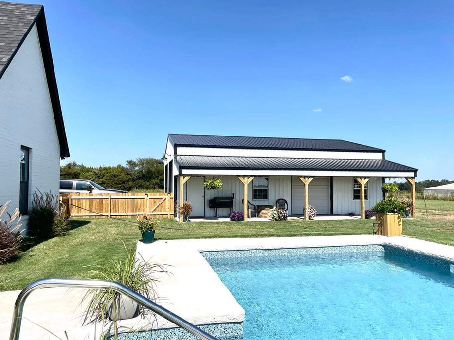 Post-frame shop with lean-to connected to backyard area