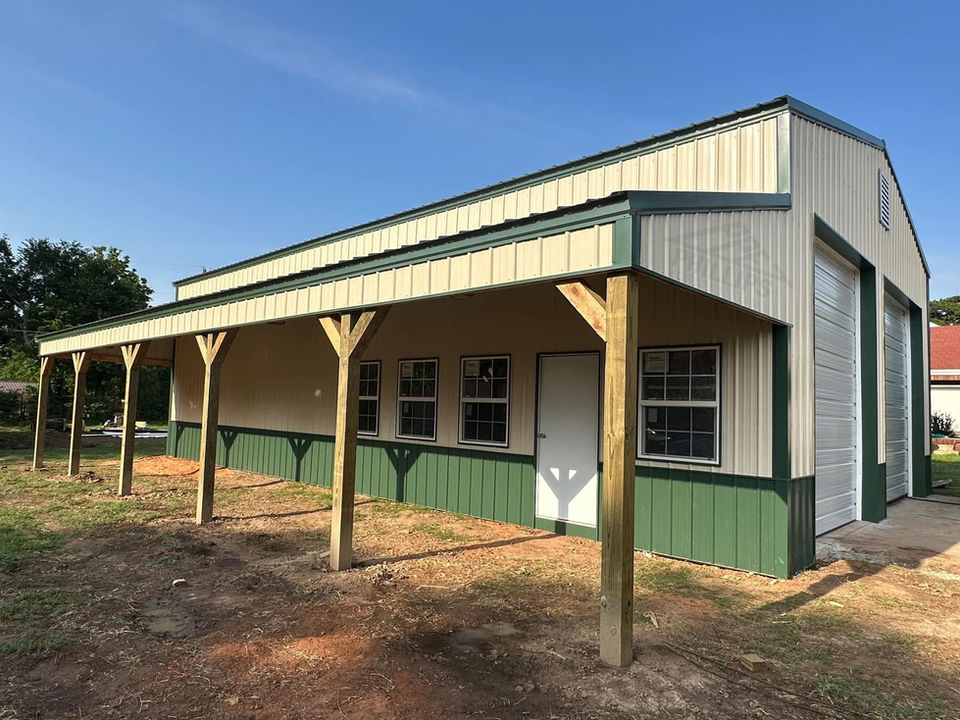 Cream-colored shop with green wainscoting and lean-to extension