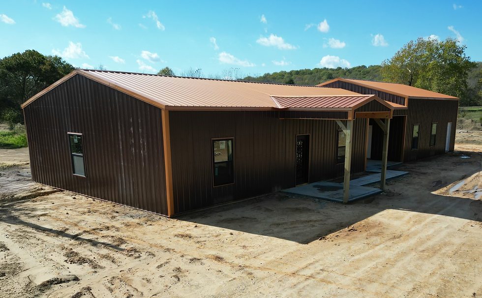 Large custom brown and orange barndominium exterior