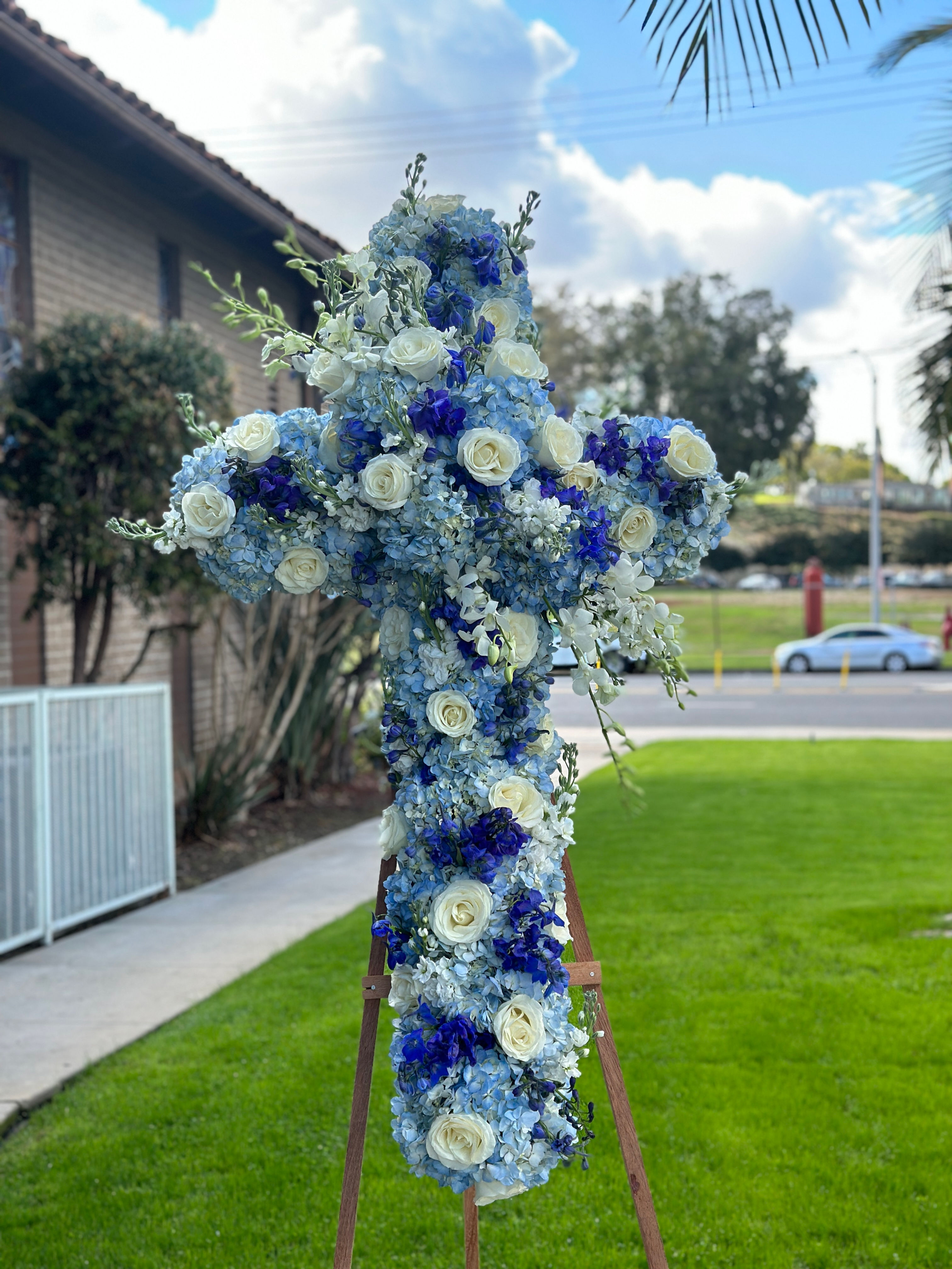 Serenity Blue Cross Funeral Floral Arrangement