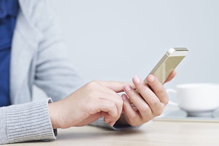 Hands-using-mobile-phone-scaled.jpeg