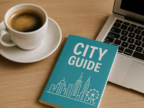 Laptop, coffee cup, and city guidebook by POOLit to learn travel networking on wooden table