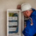 An electrician looking at a large fuse board
