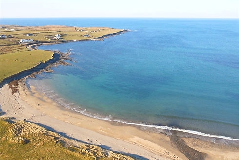 Ballycastle Beach with the former Stella Maris Coast Guard Station and Killerduff Pier in