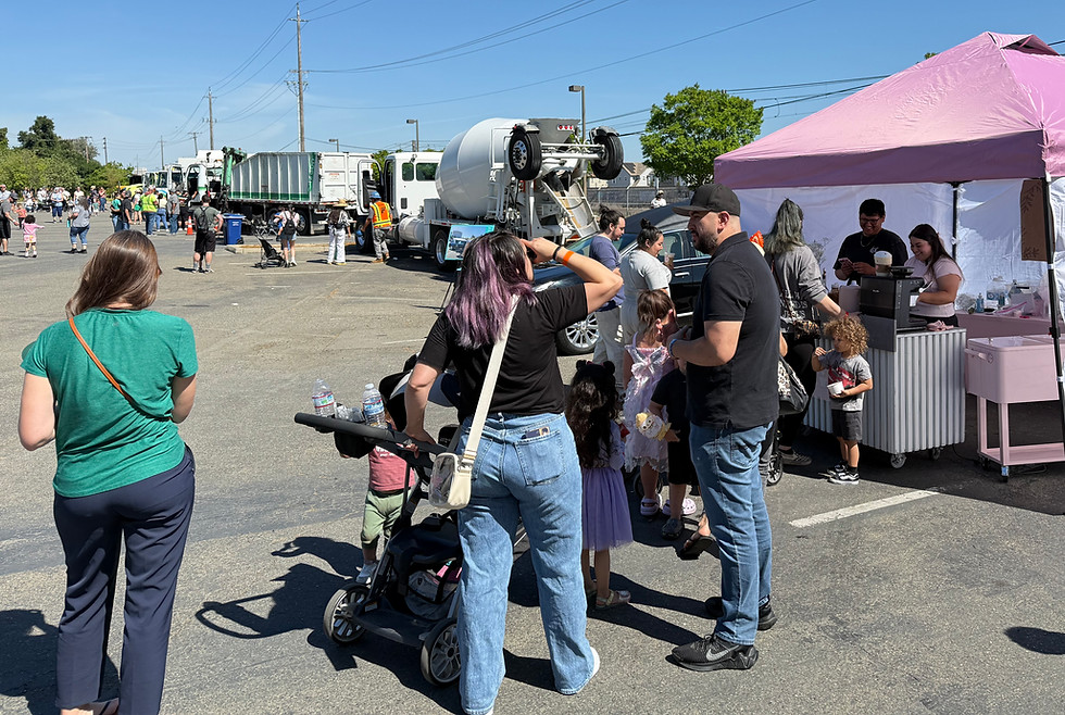 People gathered around a vendor tent at an outdoor event