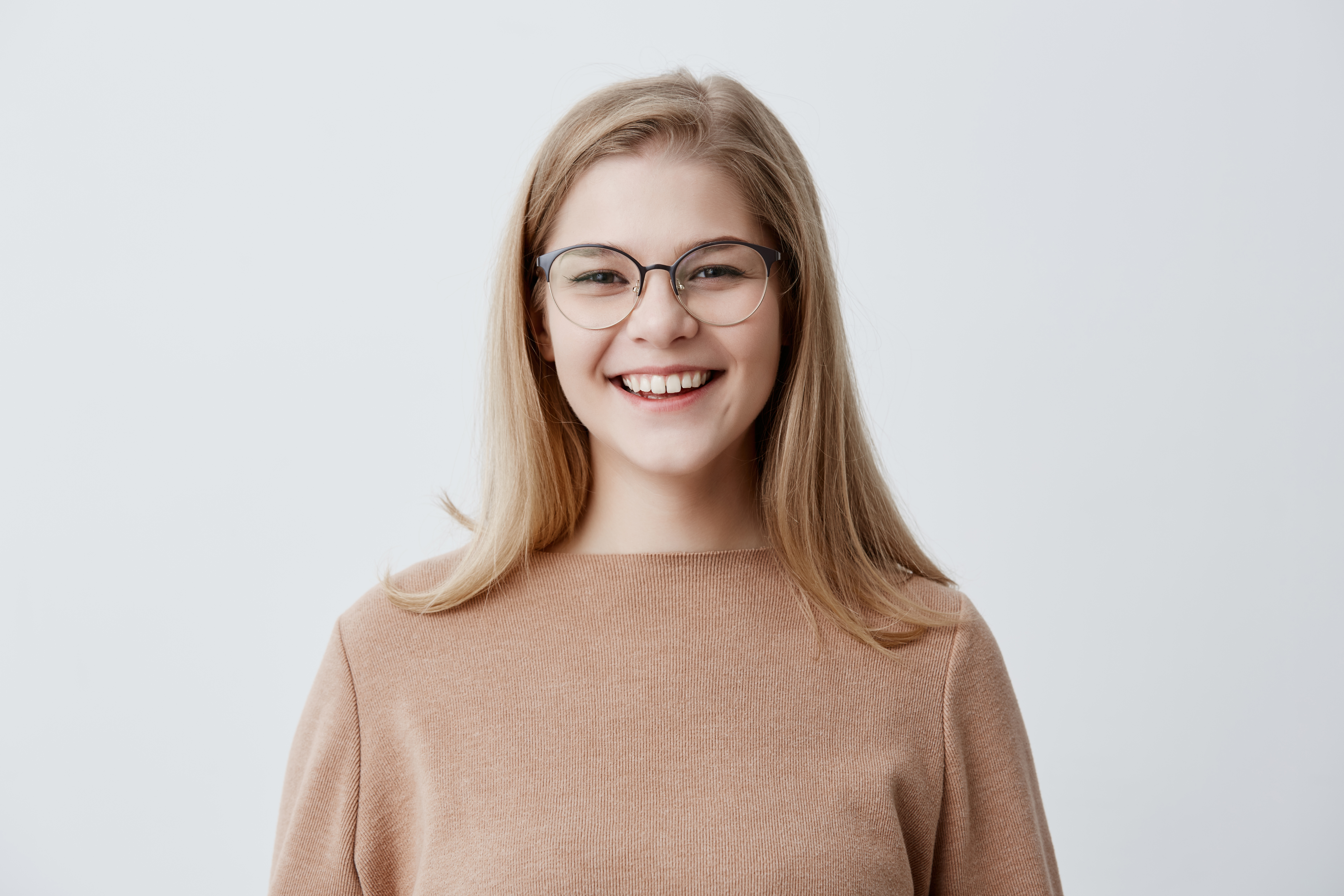 blonde-playful-young-european-female-wearing-brown-oversize-sweater-laughing-good-joke-dem