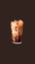 Iced coffee with milk swirling in a tall glass on brown background.