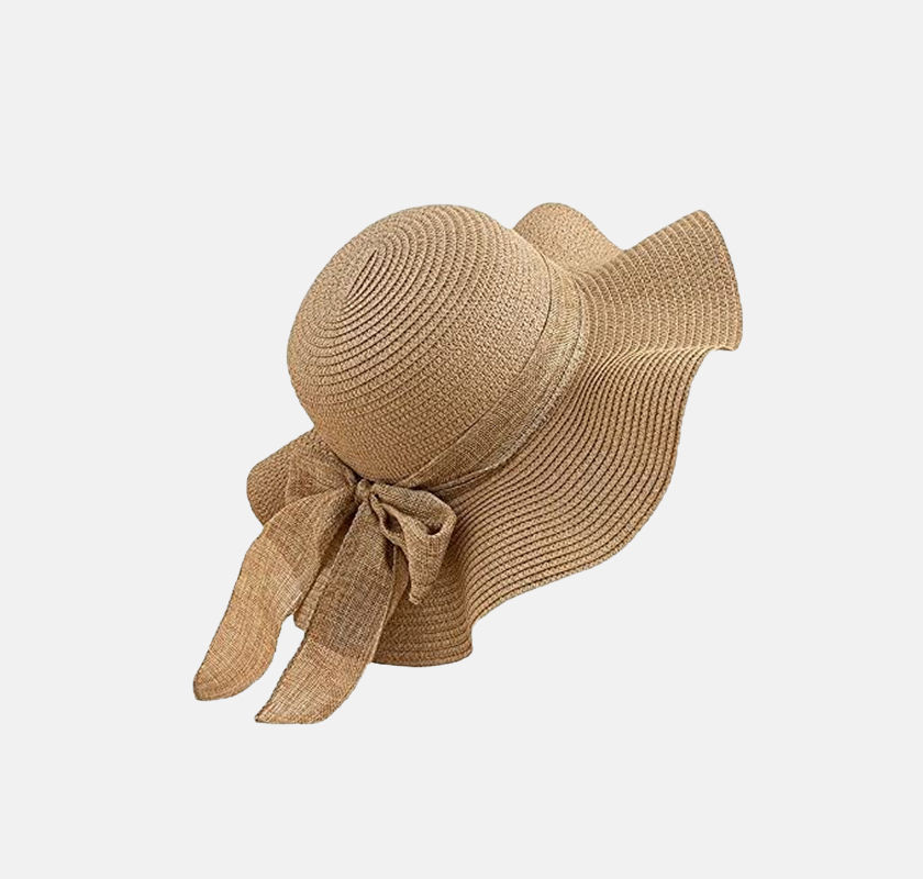 Elegant beige sun hat with a large brim and a bow detail