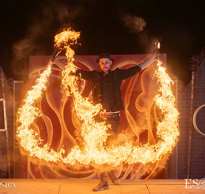Professional fire performer during a twilight fire show at an event in Melbourne