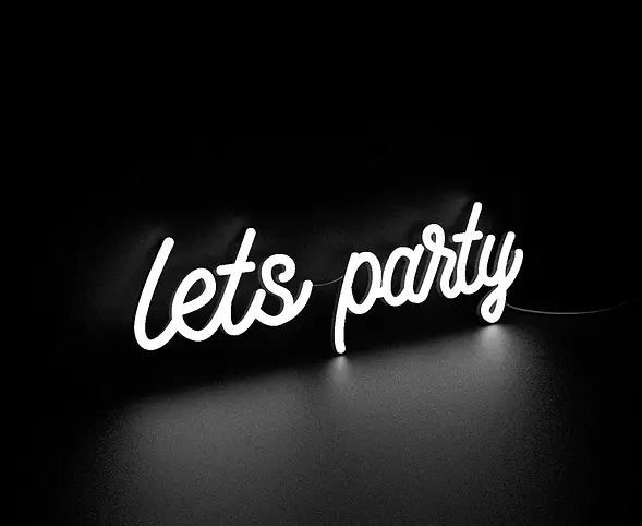 Neon “Let’s Party” sign setup beside Aeris Gallery photo booth display