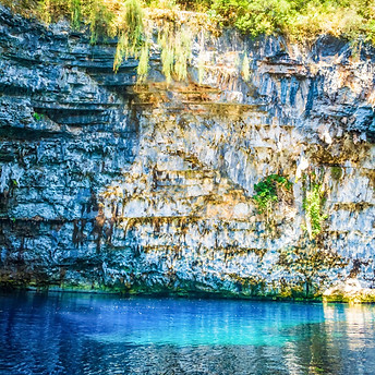Melissani Cave Kefalonia underground lake with turquoise water and sunlight entering the cave roof