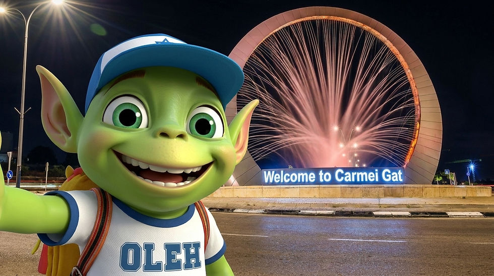 Oleh the Alien mascot taking a selfie in front of the illuminated Welcome to Carmei Gat sign at night