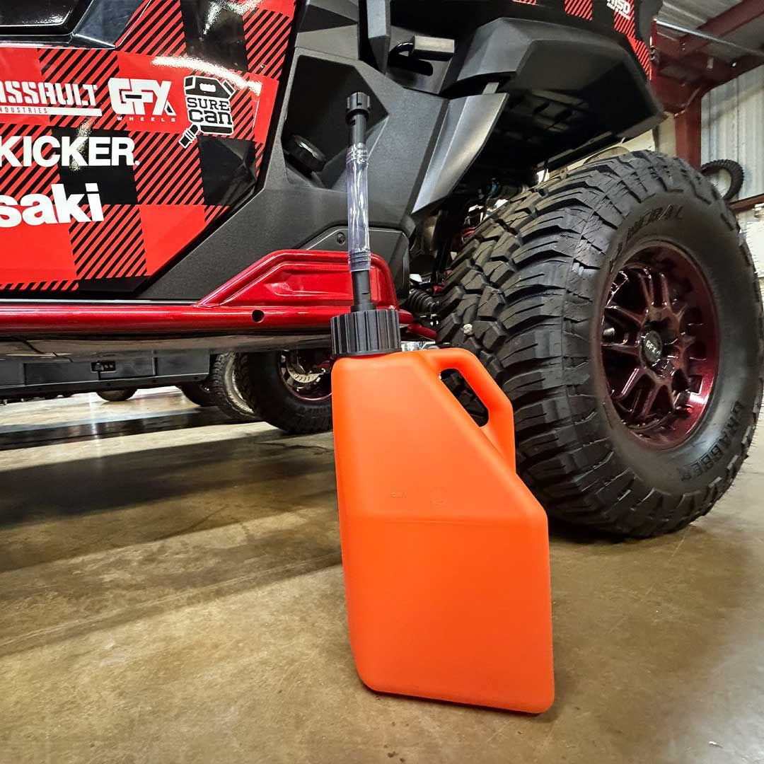 SureCan 5 Gallon Fast Flow Race Jug in front of a UTV