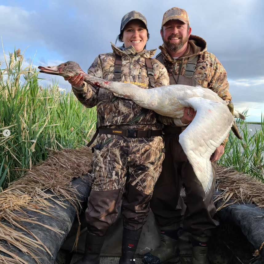 Rich and Brittany holding a swan