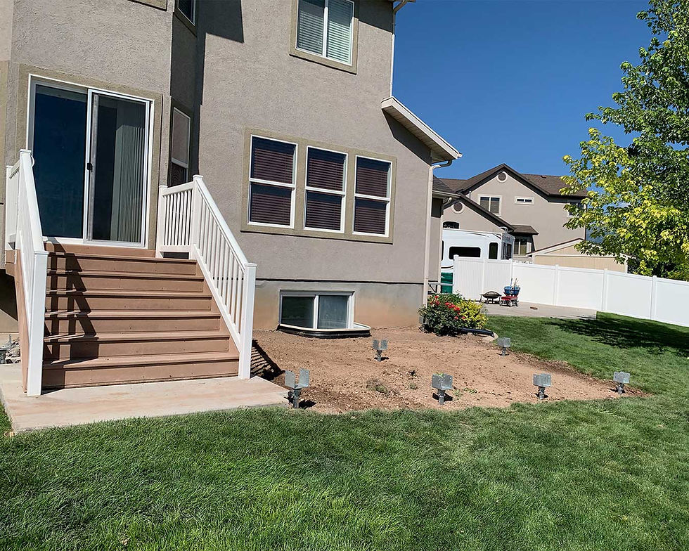 A house with a deck being installed using GoliathTech Utah helical piles
