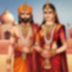 A couple in traditional, ornate attire stand before a grand palace. They wear gold jewelry, vibrant red and orange clothing, exuding elegance.