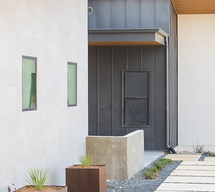 Modern building entrance with planters and path