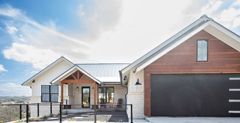 Modern farmhouse home white exterior, wood accents, black garage door.