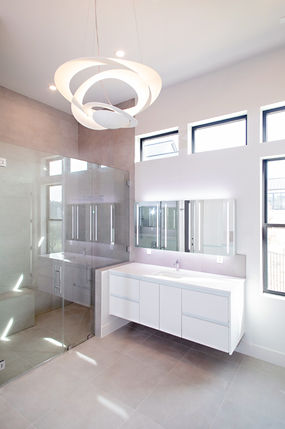 Spacious modern bathroom with glass shower and dual vanity