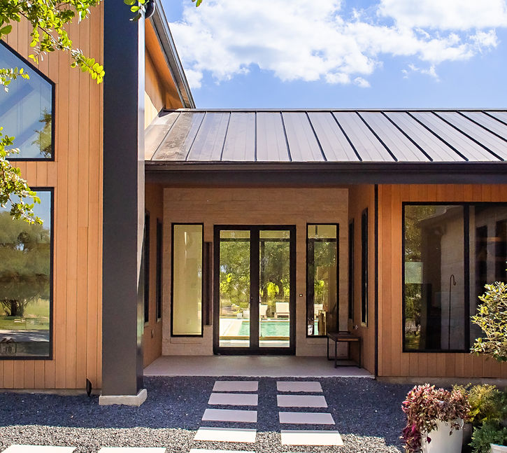 Modern house entrance with wooden siding and glass doors