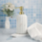 white marble soap dispenser with brass top