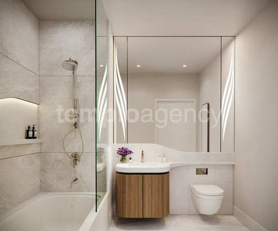 Baño con ducha de vidrio, lavabo y mueble de madera.