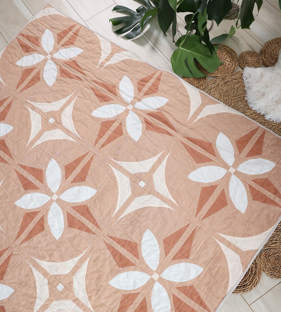 Bloom And Glow Quilt, a modern flower quilt pattern, a warm wovens version in terracotta colored fabric.
