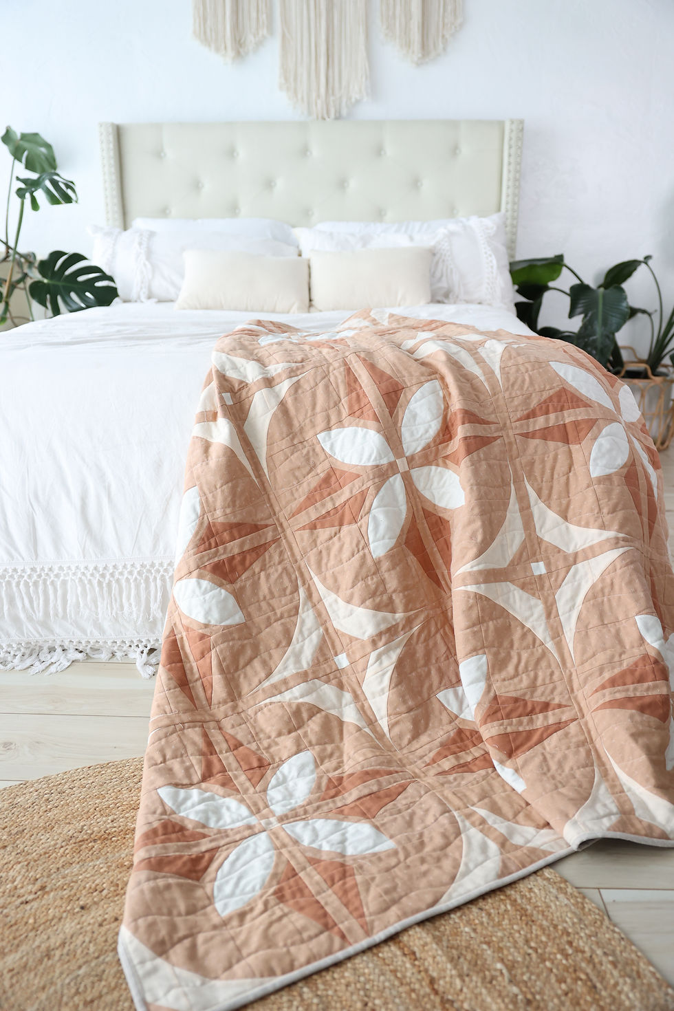 Bloom And Glow Quilt, a modern flower quilt pattern, draped on a styled bed.