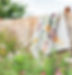 florally quilt draped on fence with wildflowers in foreground