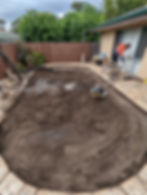 a pool being covered in compacted fresh dirt