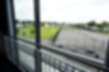 View out of window looking at the sports area and field