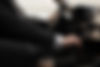 man-using-his-car-s-options-while-driving.jpg