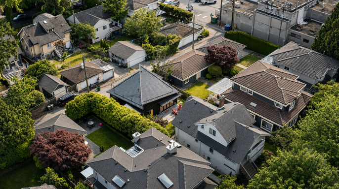 Aerial view of Japavarian Blades in a Vancouver neighbourhood with mature trees, nearby houses, gardens, and lane access.