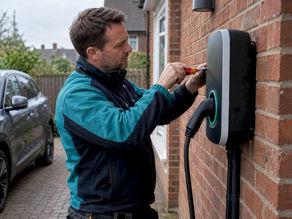 Installer fitting a home EV charge point