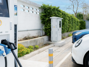 Public EV charging station with electric cars plugged in at a destination charging point in the UK, supporting sustainable travel and community infrastructure