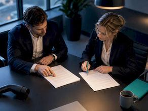 Professionals reviewing EV charging contract clauses