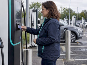 Driver using contactless payment at EV charger