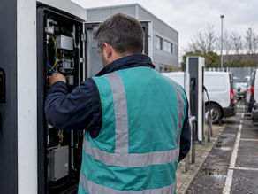 Engineer inspecting EV charger during migration