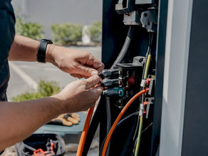 Technician hands wiring EV charger cables
