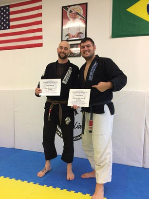 Chad Pomeroy receives his second stripe on his brown belt along with certificates from Kroyler for m