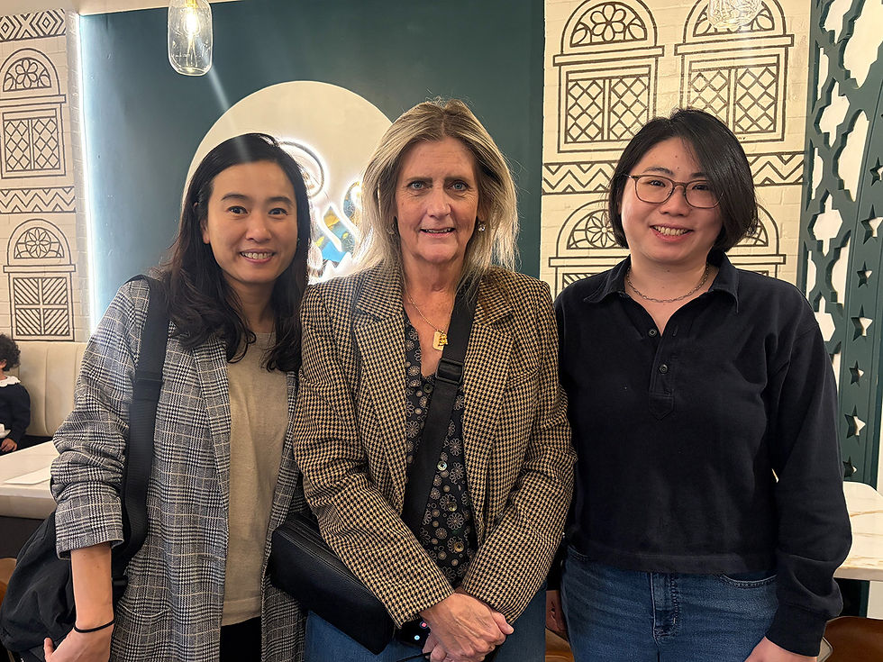 ViennArt CEO KJ Lee, SAIC Director of Admissions Sioban Lombardi, and ViennArt Head Director Ann Pan at Sheeba, a Yemeni restaurant in Vienna featuring a mural created by ViennArt students.